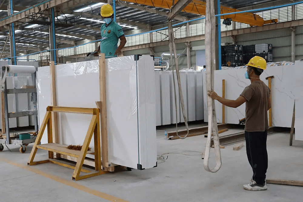 Stack of porcelain slabs in factory warehouse with forklift