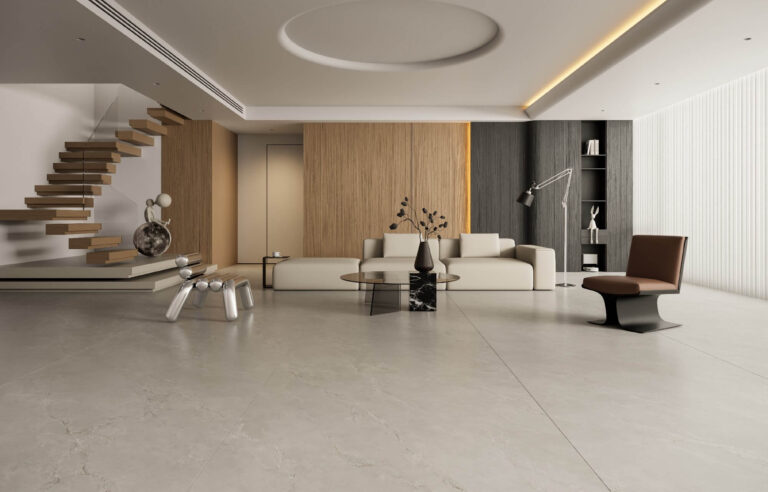Large format porcelain tile installation in modern luxury living room with high ceiling and natural lighting