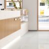 SP66AC02T Nova Speck installed floor effect photo SP66AC02T white cream beige fine speckled terrazzo look glazed polished porcelain tile installed floor effect photo commercial interior project photo glossy white floor